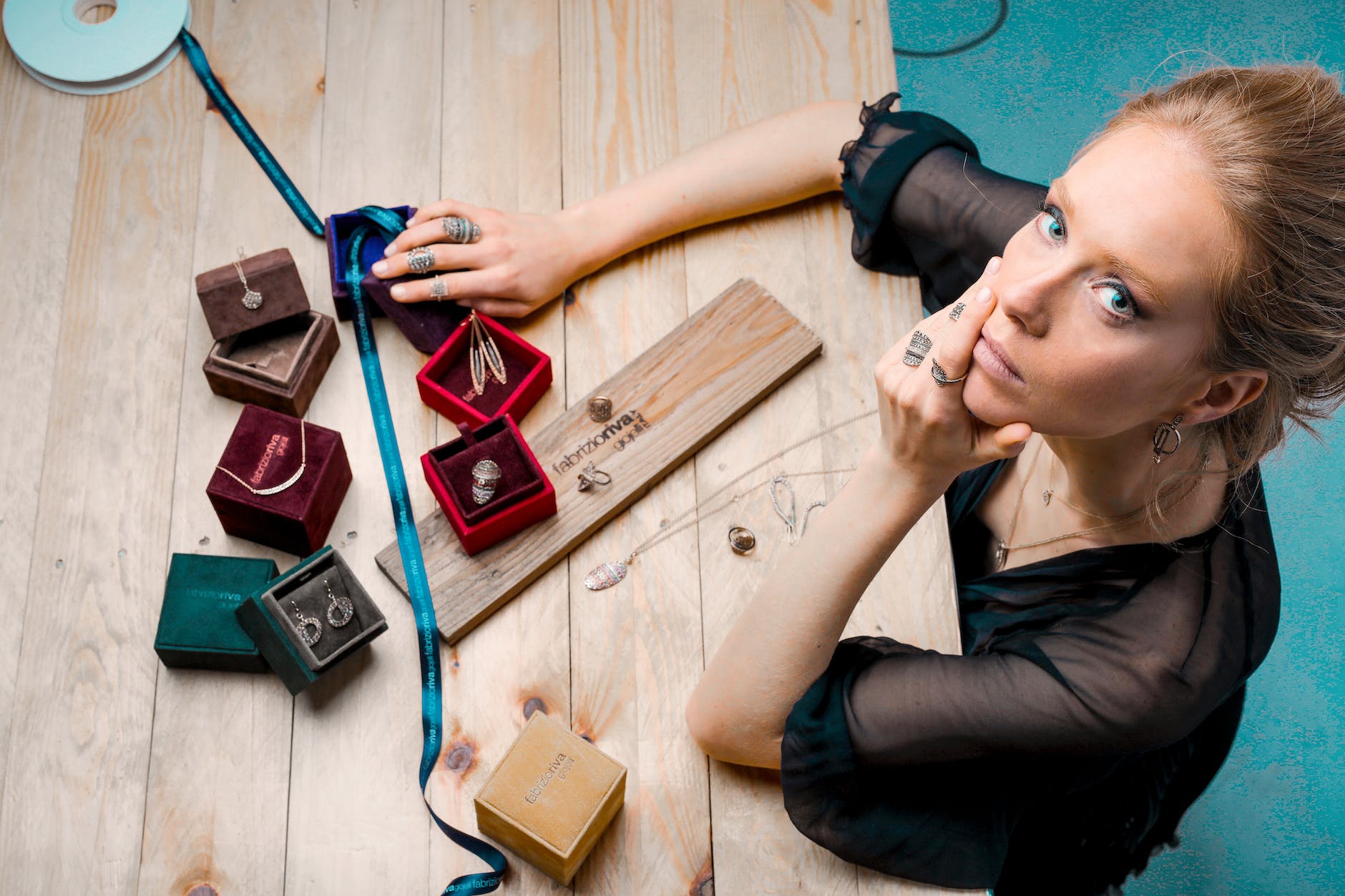 calm confident female designer with own jewelry collection in modern workshop
