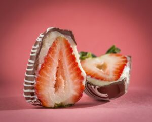 sliced strawberry coated with chocolate