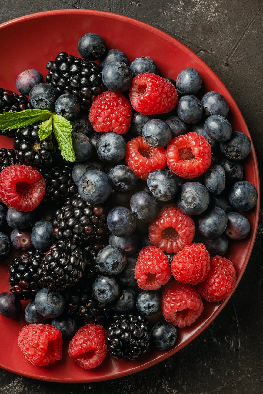 bowl with assorted fresh berries on table