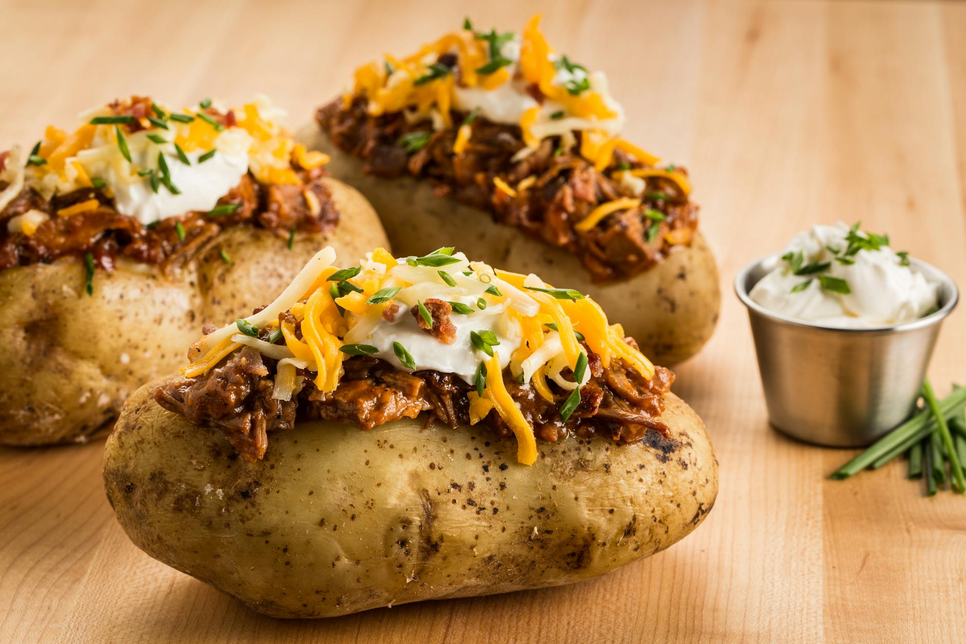 loaded bbq baked potatoes with cheese and sour cream