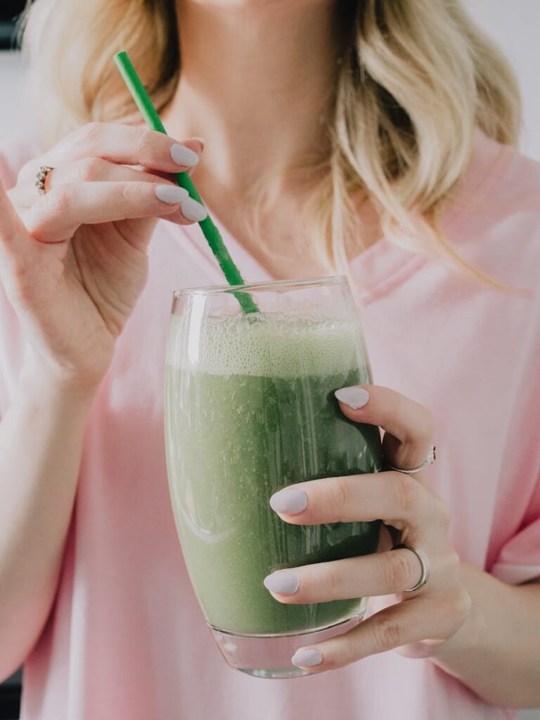 hands holding glass of smoothie