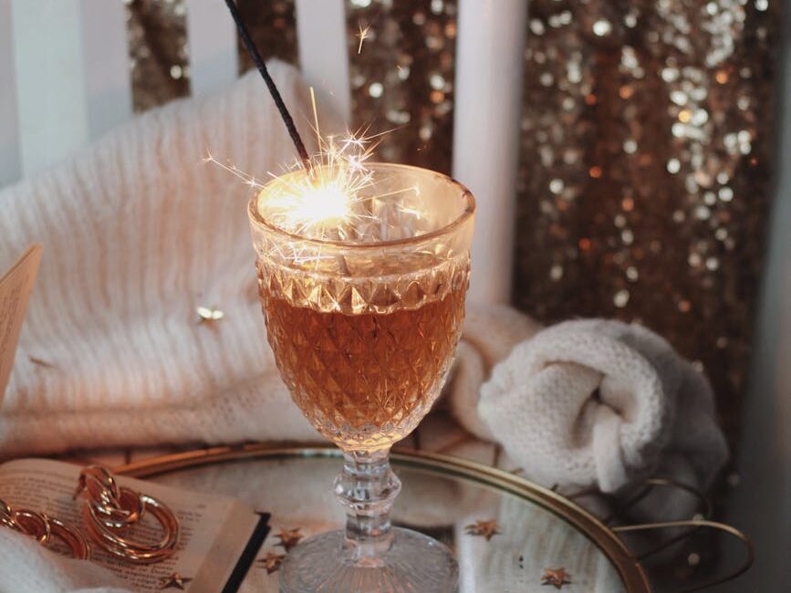 drink in a glass with lit sparkles on a coffee table