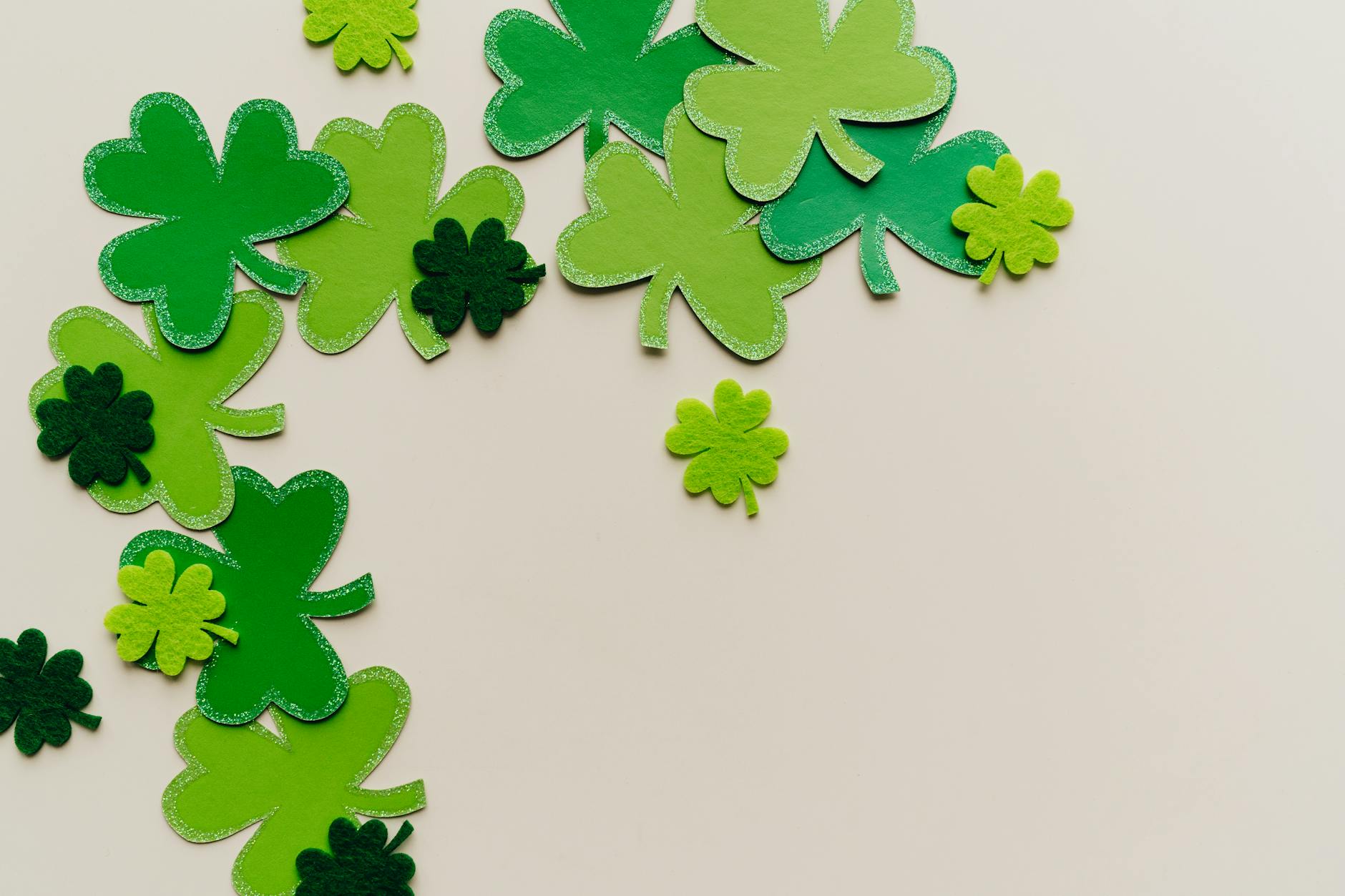 green clover shaped papers on white surface