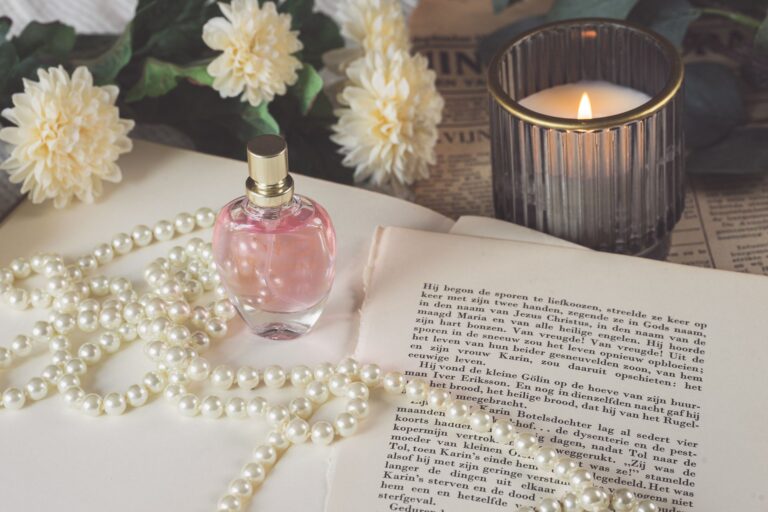 perfume bottle with pearl necklace by candle